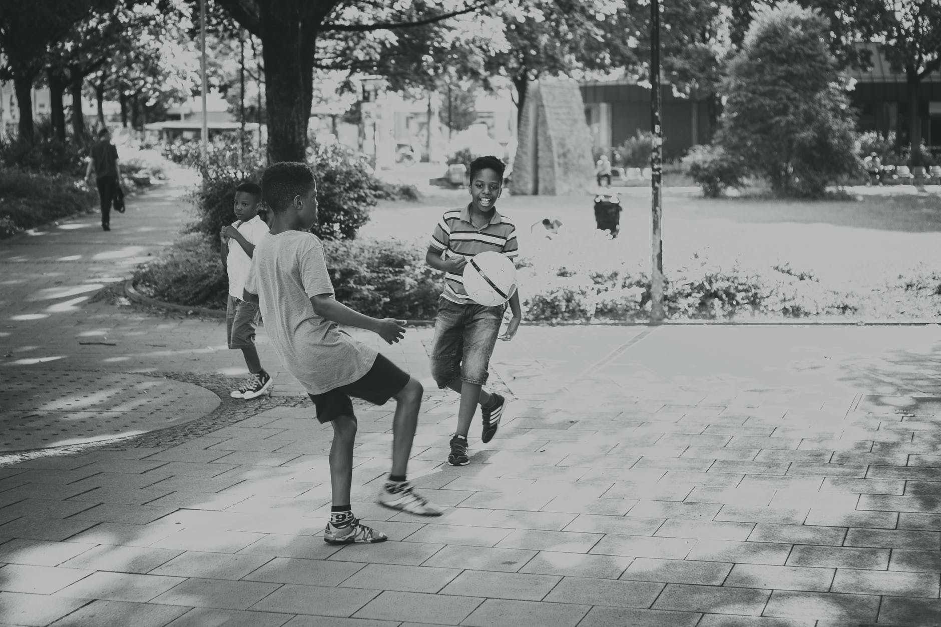 grayscale photography of kids playing ball